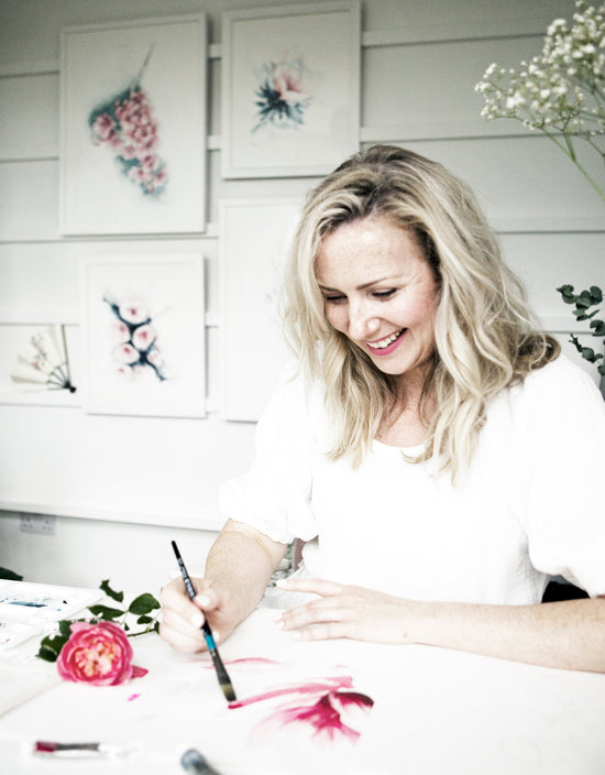 Woman painting with watercolors in a studio setting